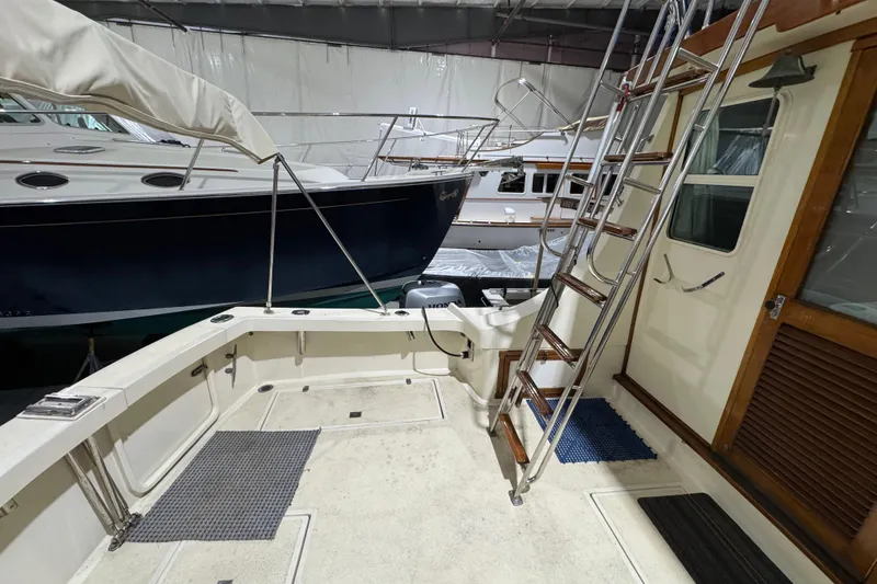 Slide: The Image of 1988 Blue Seas 31 boat interior with ladder and deck, stored indoors. - 8