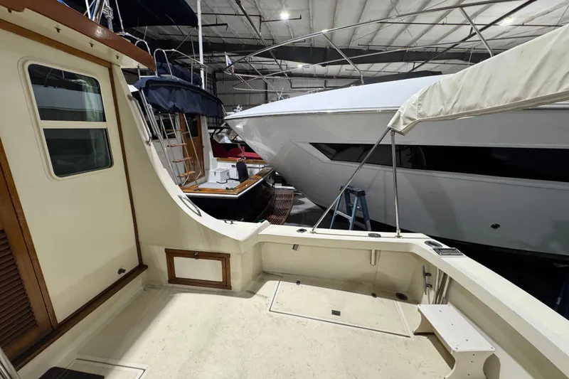 Slide: The Image of 1988 Blue Seas 31 boat interior in a marina with other vessels. - 9