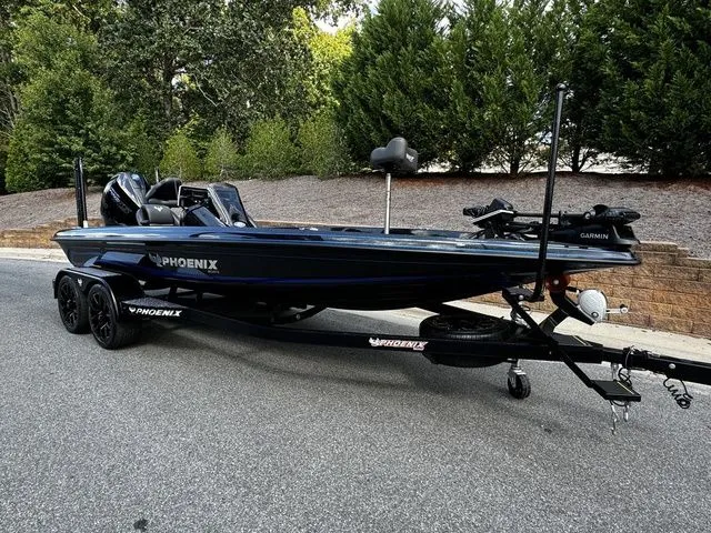 Slide: The Image of 2024 Phoenix Bass Boats 20 XE on trailer, sleek design, parked outdoors. - 1
