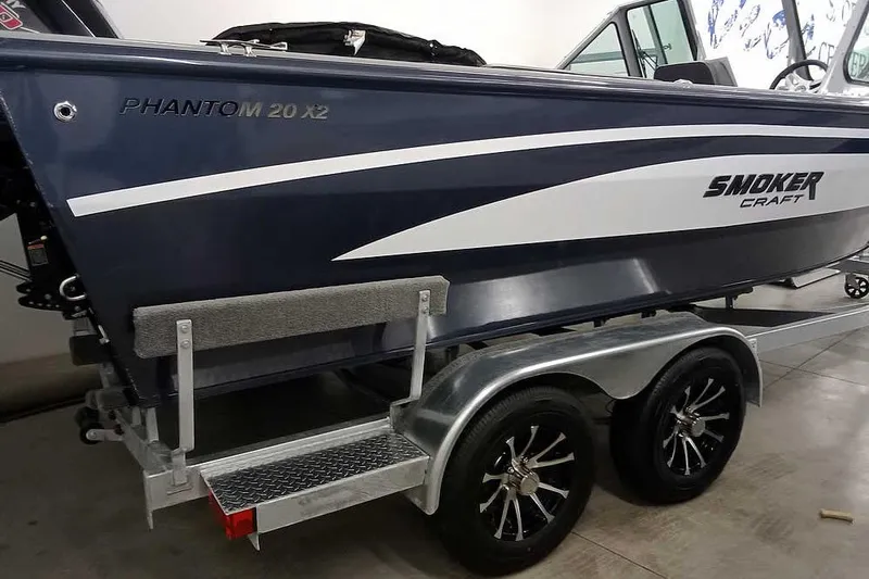 Slide: The Image of 2026 Smoker Craft Phantom 20 X2 boat on trailer, featuring sleek design and dual wheels. - 10