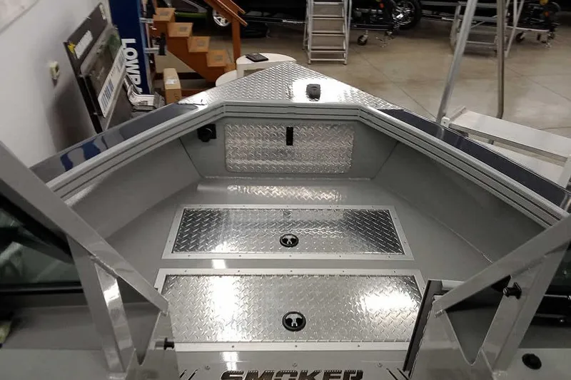 Slide: The Image of 2026 Smoker Craft Phantom 20 X2 boat interior with diamond plate flooring. - 12