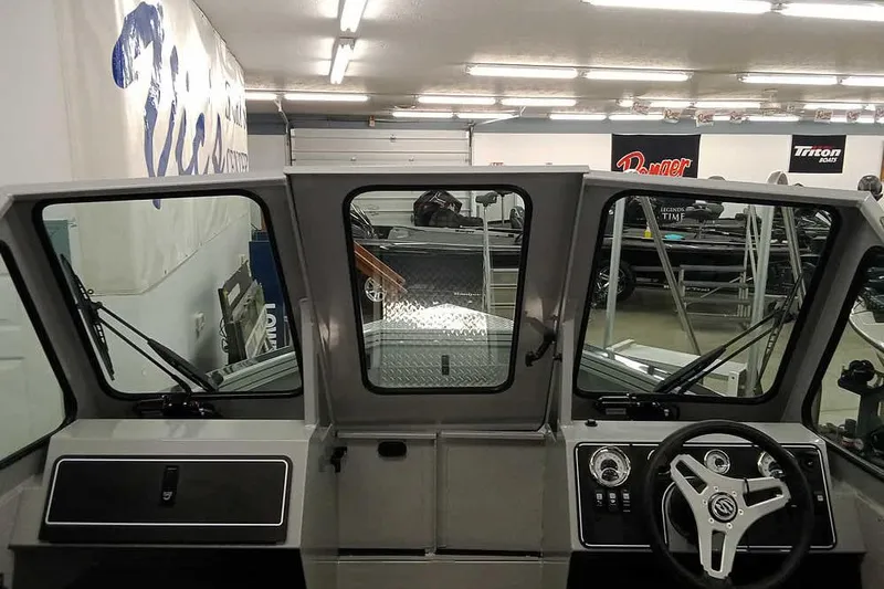 Slide: The Image of 2026 Smoker Craft Phantom 20 X2 boat interior with steering wheel and dashboard controls. - 19