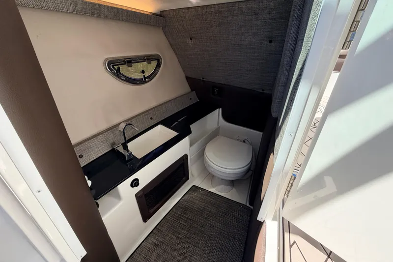 Slide: The Image of 2022 Cobalt R8 Outboard boat interior with sink and toilet. - 13