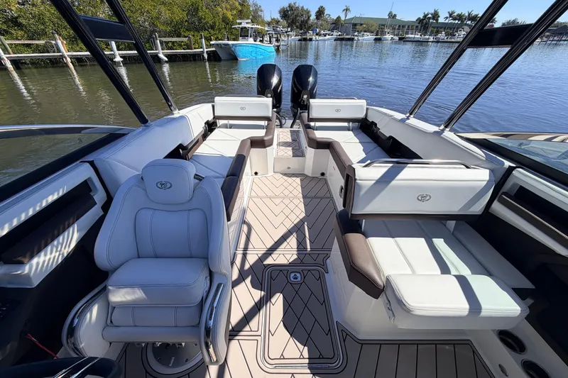 Slide: The Image of 2022 Cobalt R8 Outboard boat interior with luxurious seating and modern design on a calm waterway. - 9