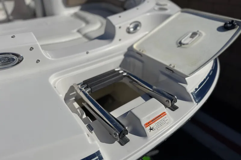 Slide: The Image of 2005 Four Winns 194 Funship boat with open storage compartment and ladder. - 11