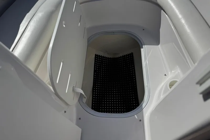 Slide: The Image of 2005 Four Winns 194 Funship boat storage compartment with open hatch and black mat. - 15