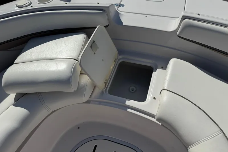 Slide: The Image of 2005 Four Winns 194 Funship boat interior with open storage compartment and white seating. - 16