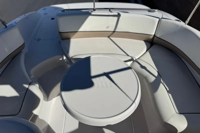 Slide: The Image of 2005 Four Winns 194 Funship boat interior with round table and cushioned seating. - 18