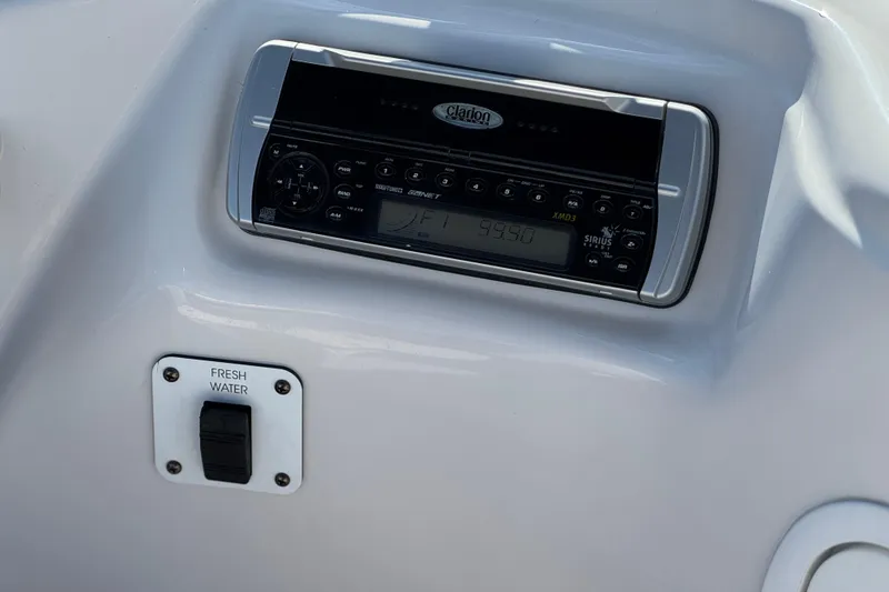Slide: The Image of 2005 Four Winns 194 Funship boat dashboard with Clarion stereo and fresh water switch. - 23