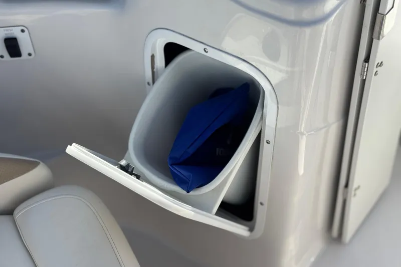 Slide: The Image of Storage compartment on a 2005 Four Winns 194 Funship boat, featuring a blue item inside. - 25