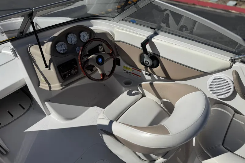 Slide: The Image of 2005 Four Winns 194 Funship boat interior with steering wheel and dashboard controls. - 26