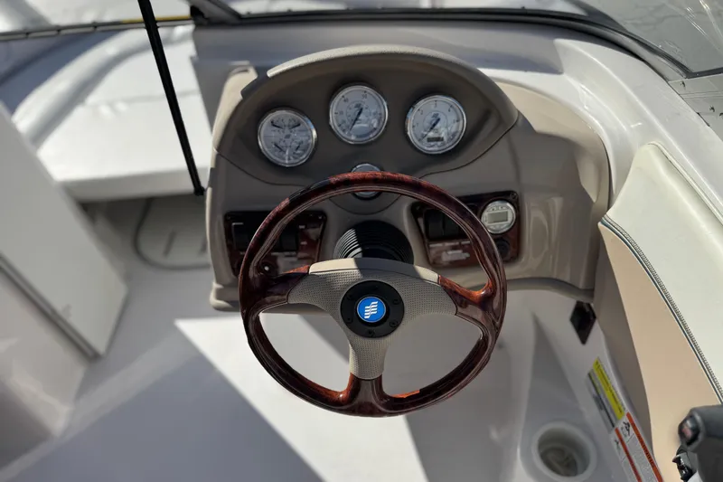 Slide: The Image of 2005 Four Winns 194 Funship boat dashboard with steering wheel and gauges. - 27