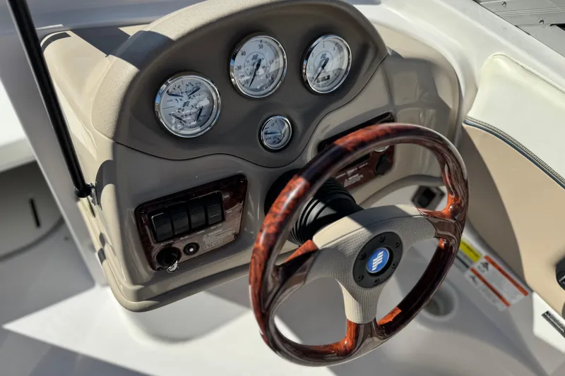 Slide: The Image of 2005 Four Winns 194 Funship dashboard with gauges and wood-accented steering wheel. - 28