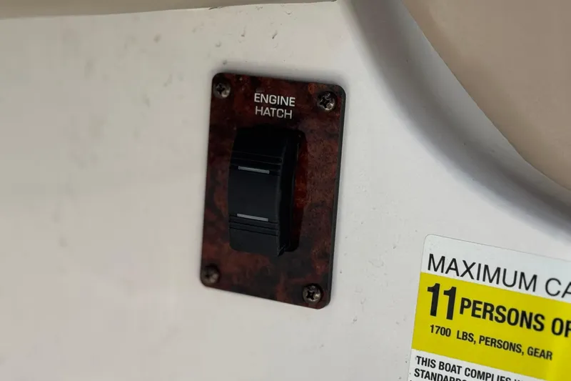 Slide: The Image of 2005 Four Winns 194 Funship engine hatch switch and capacity label. - 29