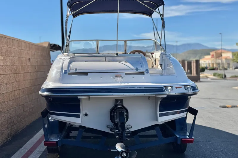 Slide: The Image of 2005 Four Winns 194 Funship boat on trailer, parked outdoors. - 4