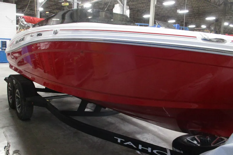 Slide: The Image of 2025 Tahoe 210 S boat in a showroom, red hull on a trailer. - 3