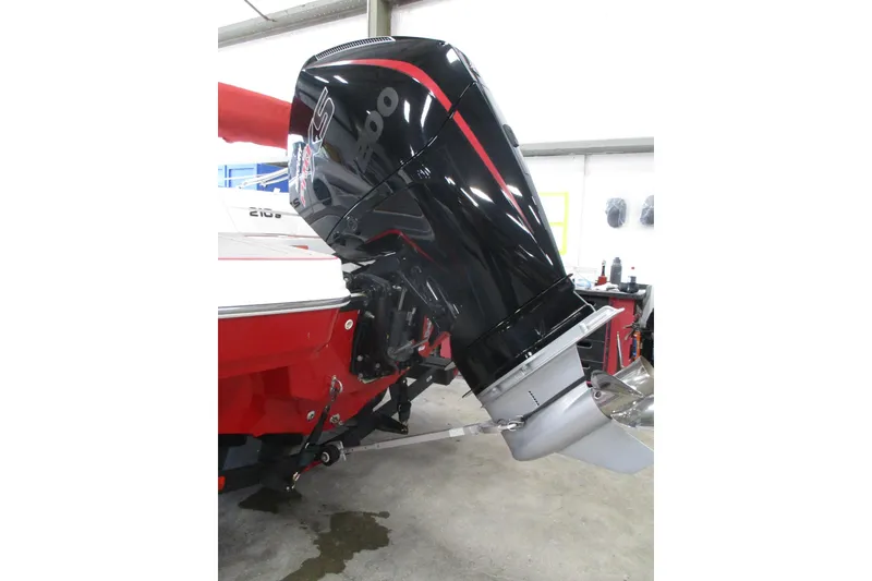 Slide: The Image of 2025 Tahoe 210 S boat with a powerful black and red outboard motor. - 7