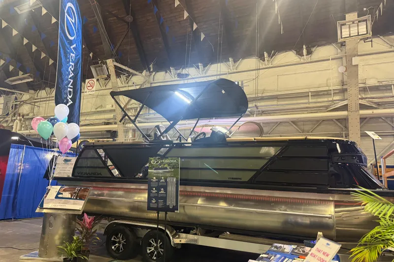 Slide: The Image of 2026 Veranda VX 235 RC boat displayed indoors with balloons and promotional materials. - 12