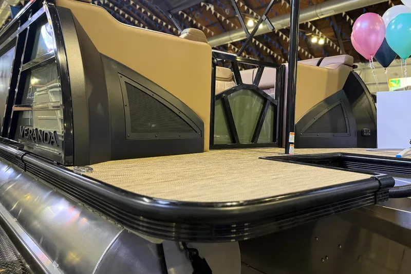 Slide: The Image of 2026 Veranda VX 235 RC pontoon boat interior with seating and balloons in a showroom. - 15
