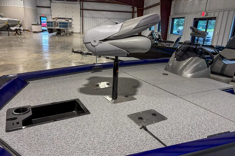 Slide: The Image of 2025 G3 Sportsman 1810 boat interior with seating and storage compartments in a showroom. - 3