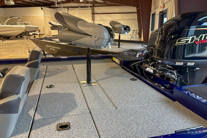 Slide: The Image of 2025 G3 Sportsman 1810 boat interior with motor, in a showroom setting. - 5