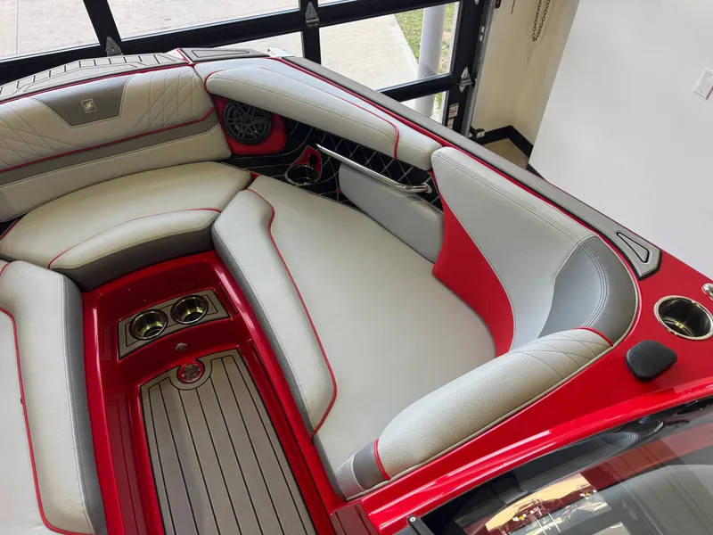 Slide: The Image of 2020 Nautique Super Air Nautique GS24 boat interior, red and gray seating. - 18