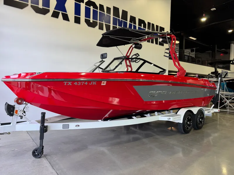 Slide: The Image of Red 2020 Nautique Super Air Nautique GS24 boat on trailer. - 2
