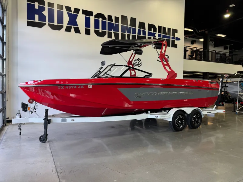 Slide: The Image of Red 2020 Nautique Super Air Nautique GS24 boat in showroom. - 3