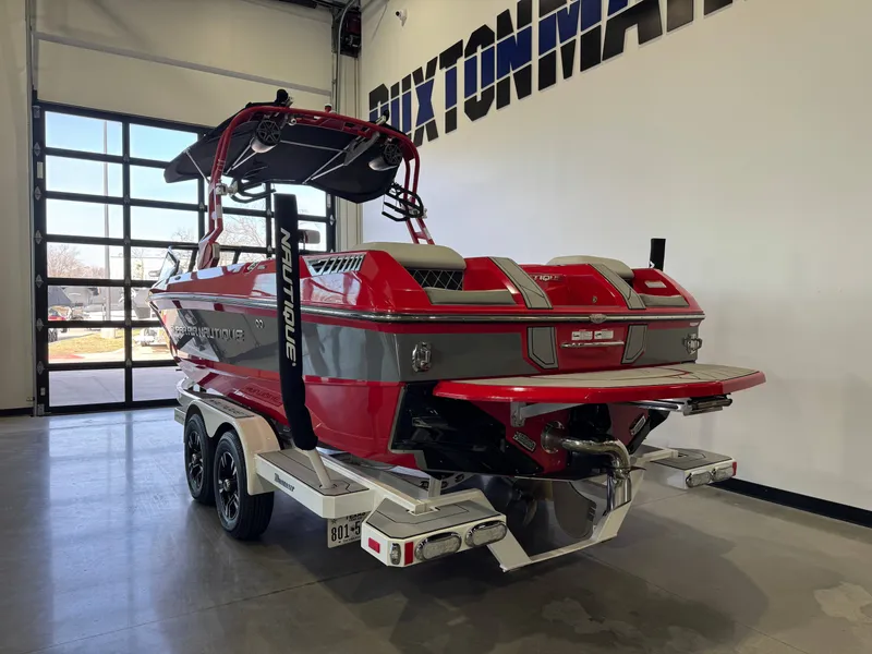 Slide: The Image of Red 2020 Nautique Super Air Nautique GS24 boat in a showroom. - 5