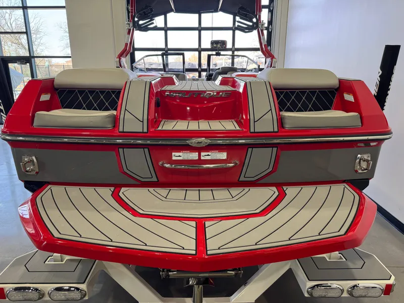 Slide: The Image of Red 2020 Nautique Super Air Nautique GS24 boat in showroom. - 8