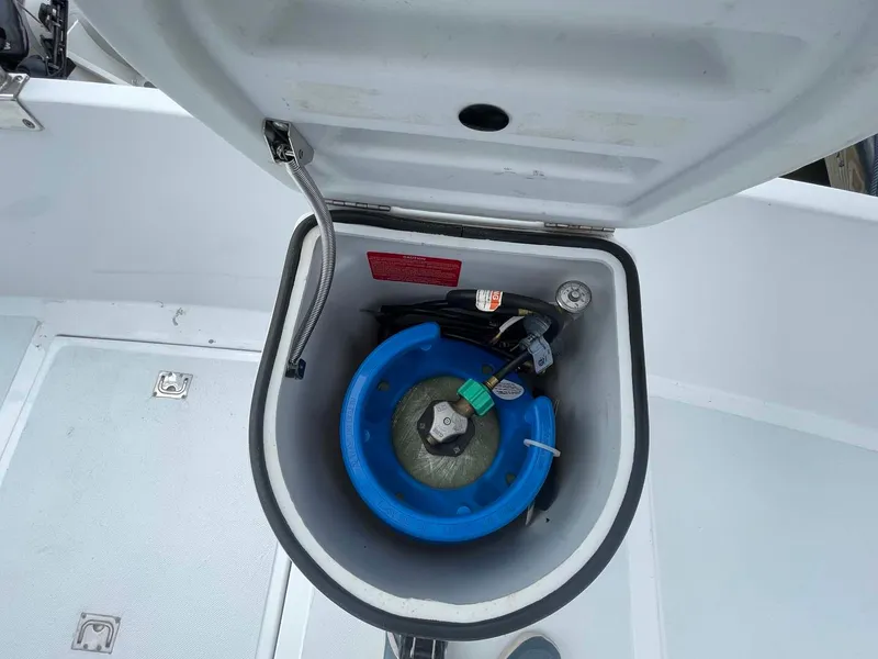 Slide: The Image of Open storage compartment on 1985 DeFever 40 Offshore Cruiser with blue propane tank. - 38