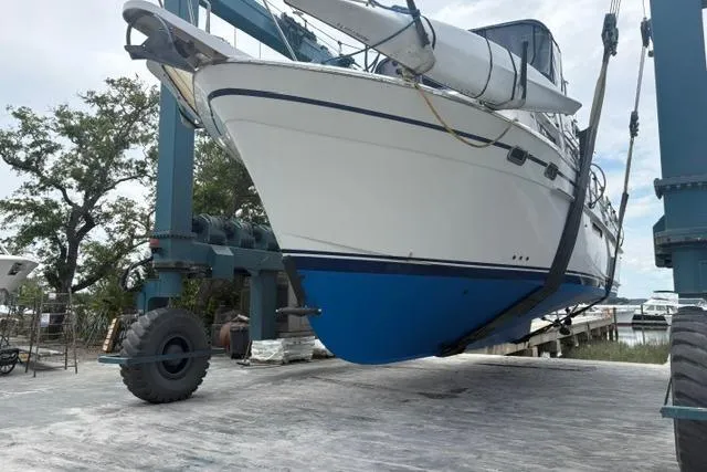 Slide: The Image of 1985 DeFever 40 Offshore Cruiser in dry dock, suspended by a boat lift. - 48