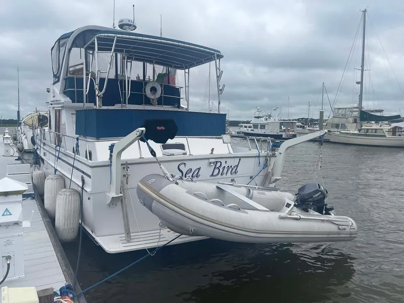 Slide: The Image of 1985 DeFever 40 Offshore Cruiser "Sea Bird" docked with inflatable dinghy attached. - 5