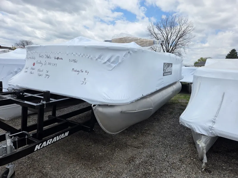 Slide: The Image of 2026 Bentley Pontoons LE 180 3-Point covered on trailer. - 3