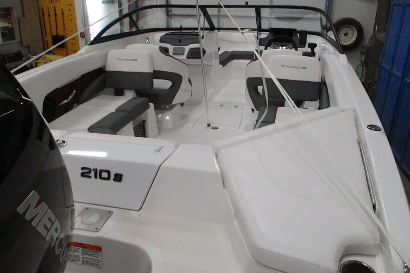 Slide: The Image of 2025 Tahoe 210 S boat interior with seating and steering wheel. - 2
