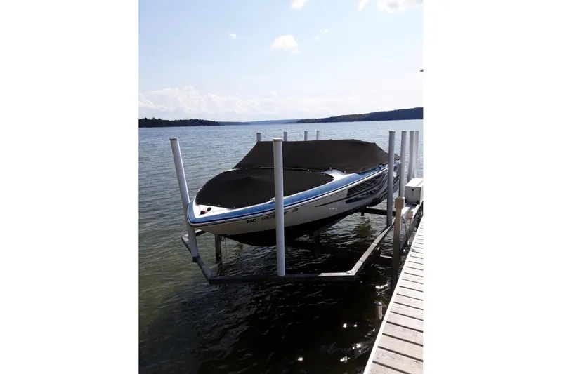 The Image of 2018 Regal 1900 ESX Bowrider on a boat lift by a dock. - 0