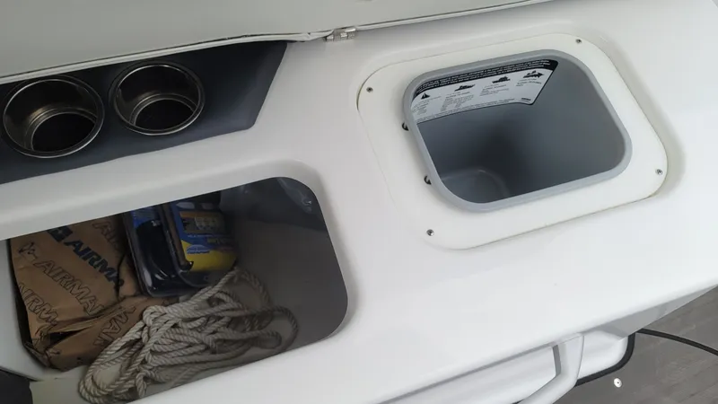 Slide: The Image of Interior of 2023 Scarab 285 ID with storage and cup holders. - 16