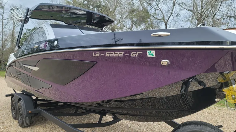 Slide: The Image of 2023 Scarab 285 ID boat on trailer, purple and black. - 24