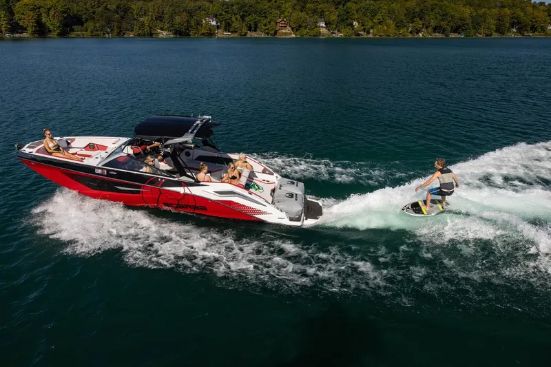 Slide: The Image of 2023 Scarab 285 ID boat with wakeboarder on a lake. - 35