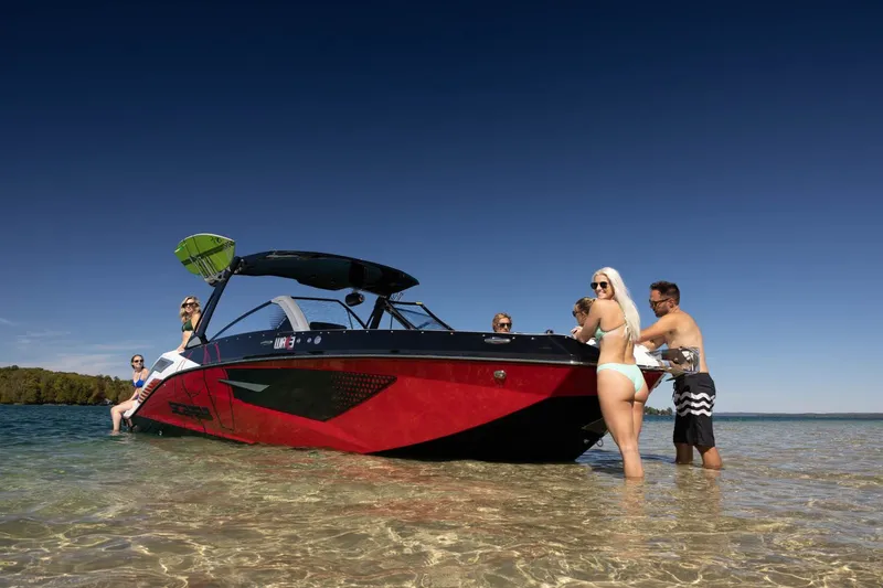 Slide: The Image of 2023 Scarab 285 ID boat with people at the beach. - 38