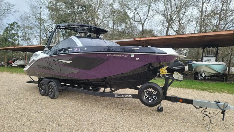 Slide: The Image of 2023 Scarab 285 ID boat parked on trailer outdoors. - 5