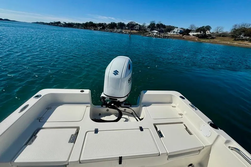Slide: The Image of 2025 Bulls Bay 2200 XS boat with Suzuki outboard motor on calm water. - 10