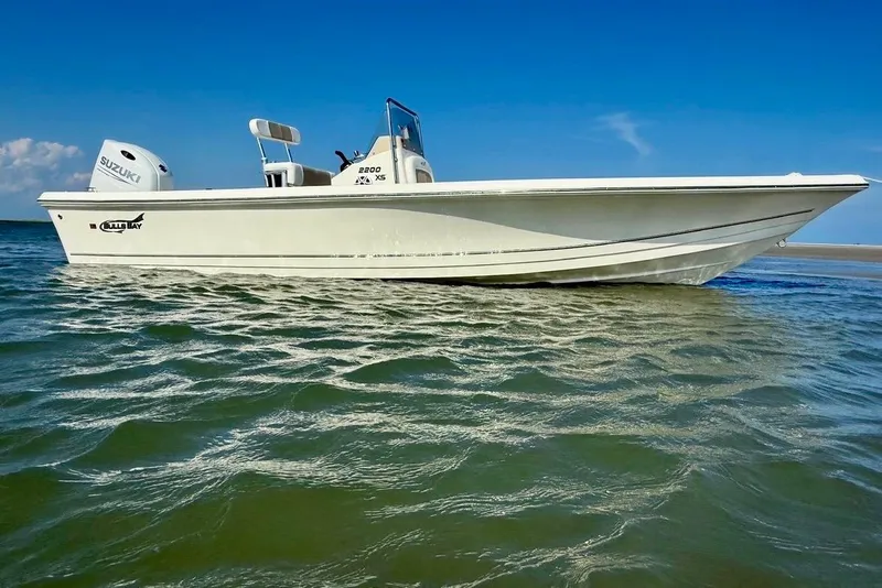 Slide: The Image of 2025 Bulls Bay 2200 XS boat on calm water under clear blue sky. - 13