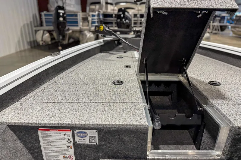 Slide: The Image of 2026 Smoker Craft Viper XR 165 boat interior with open storage compartment. - 10