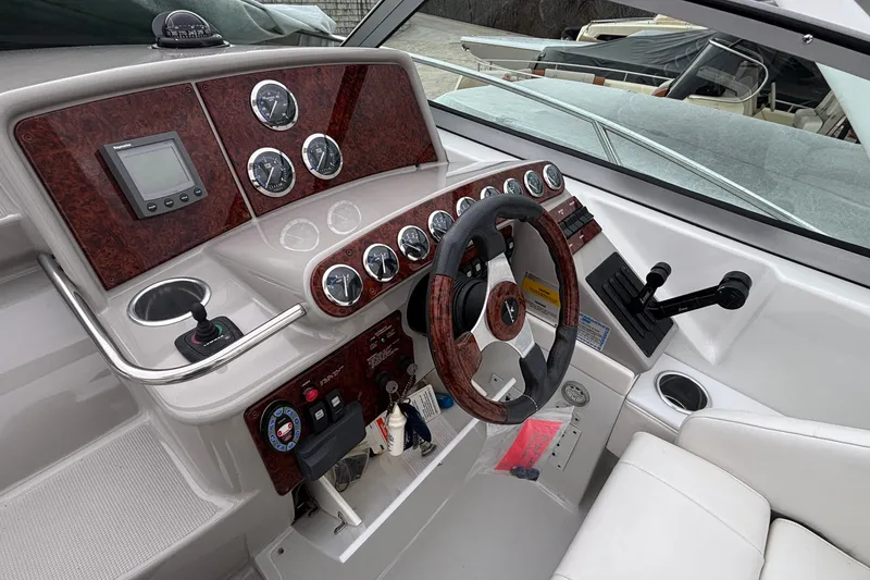 Slide: The Image of 2005 Formula 31 Performance Cruiser helm with wood accents and modern controls. - 3