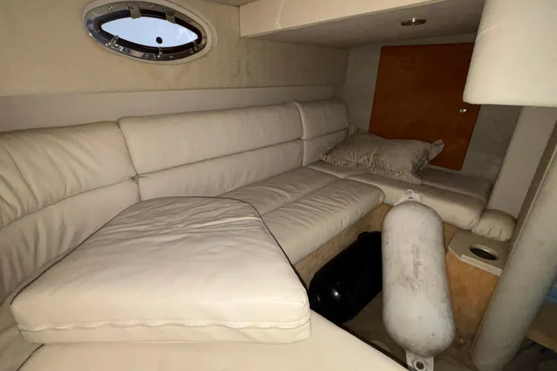 Slide: The Image of 2005 Formula 31 Performance Cruiser interior with white leather seating and porthole window. - 48