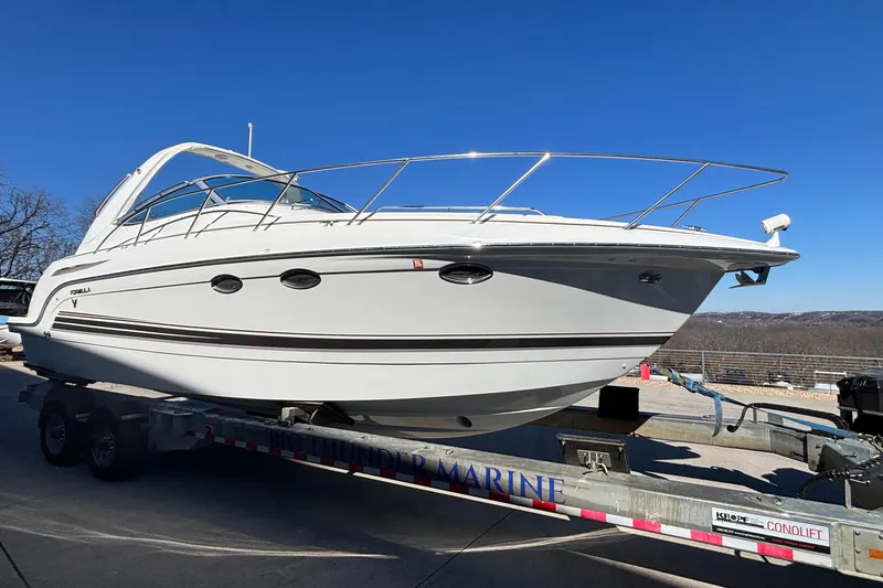 Slide: The Image of 2005 Formula 31 Performance Cruiser on trailer under clear blue sky. - 49