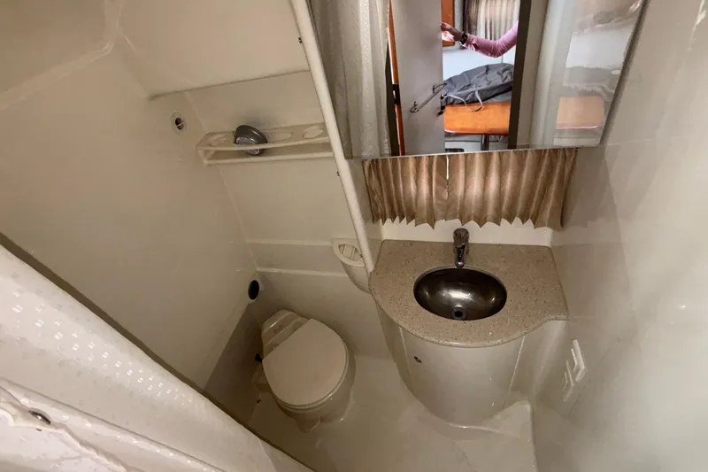 Slide: The Image of 2005 Formula 31 Performance Cruiser bathroom with sink, toilet, and mirror. - 55