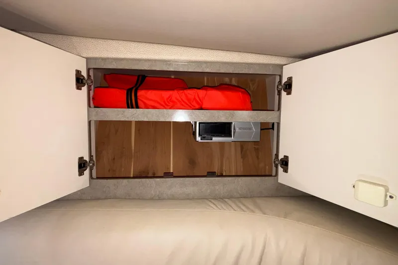 Slide: The Image of Open cabinet in 2005 Formula 31 Performance Cruiser with life jacket and Kenwood stereo. - 59