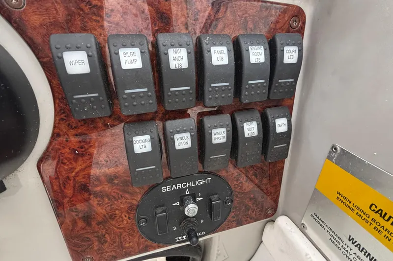 Slide: The Image of Control panel of a 2005 Formula 31 Performance Cruiser with labeled switches. - 6
